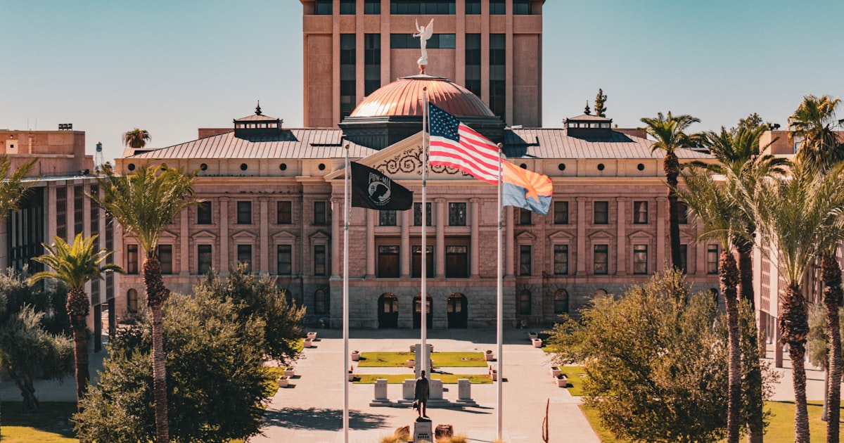 Arizona State Capitol building with state flag in foreground